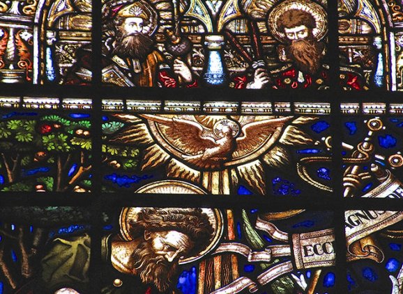 Detail of a stained glass window from Trinity with dove descending.