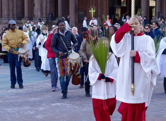 Acolytes and drummers lead the Palm Sunday procession.