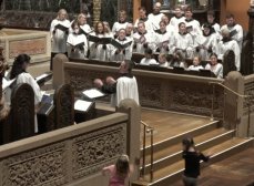 The Trinity choir and choristers sing 'Sign me up' by Brandon A. Boyd. Colin Lynch directs. Two young parishioners dance to the music in front of the broad step.