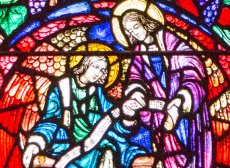 two angels in red, green, purple, and blue stained glass