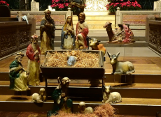 the nativity scene is depicted with a creche on the steps of Trinity Church Boston's broad step.