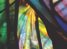 Stained glass swirl of purple, green, yellow, and turquoise