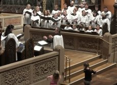 The Trinity choir and choristers sing 'Sign me up' by Brandon A. Boyd. Colin Lynch directs. Two young parishioners dance to the music in front of the broad step.