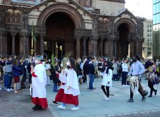 parishioners and drummers from Rambax MIT march across Copley Square as part of the Palm Sunday Procession in 2022
